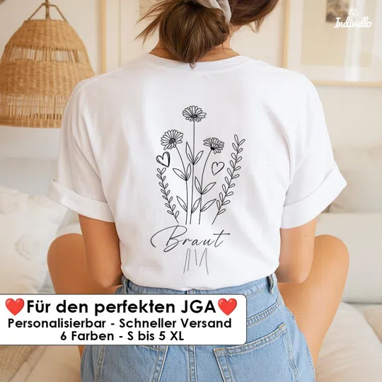 Personalisiertes JGA-Shirt kaufen: weißes T-Shirt in Rückenansicht mit schwarzer Blumenzeichnung, Herzen und dem Schriftzug „Braut“. Das Motiv steht mittig auf dem Rücken.